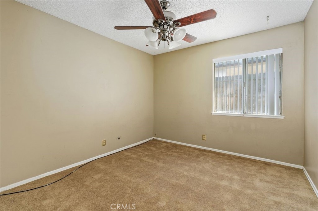 786 Spruce Street Riverside, CA 92507 - Photo 18 of 29 an empty room with windows and fan