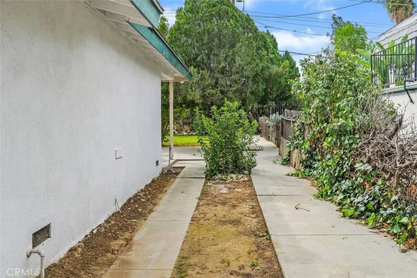 a view of a backyard with potted plants