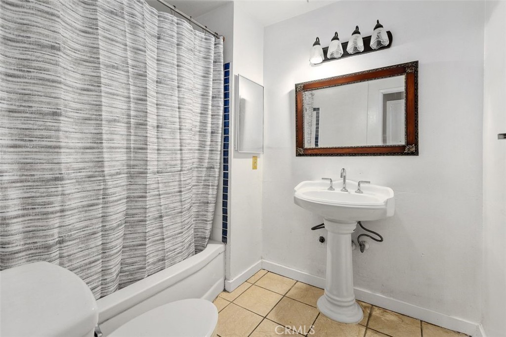 786 Spruce Street Riverside, CA 92507 - Photo 21 of 29 a bathroom with a sink a mirror and shower
