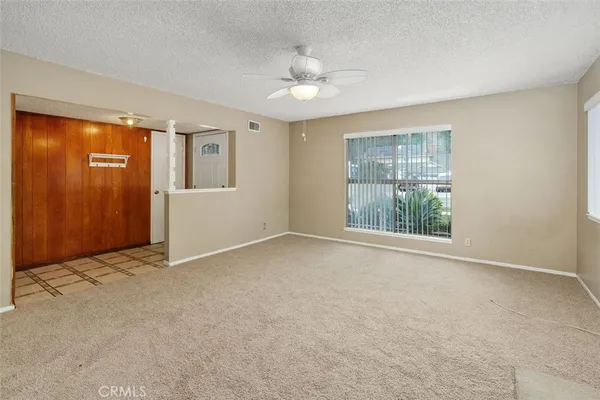 an empty room with windows and closet