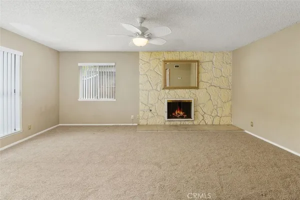 a view of empty room with a fireplace