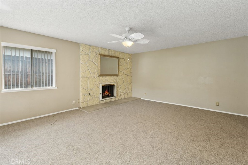 786 Spruce Street Riverside, CA 92507 - Photo 8 of 29 an empty room with windows and fireplace