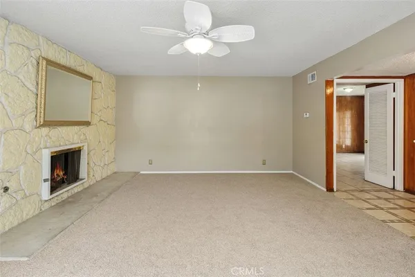 a view of empty room with fireplace