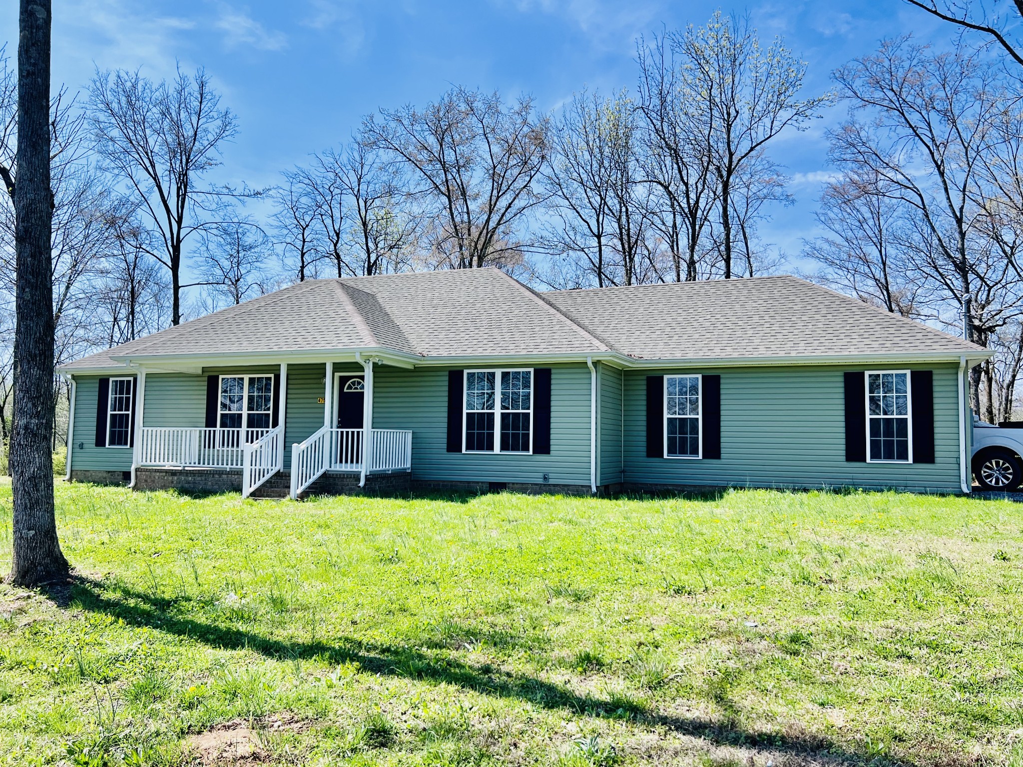 a view of a house with a yard porch and sitting area