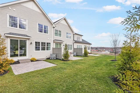 a view of a house with backyard sitting area and garden