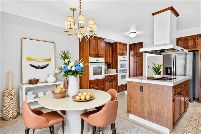 a view of a dining room with furniture and chandelier