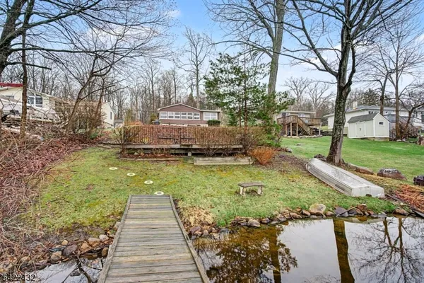 an aerial view of residential houses with outdoor space and lake view
