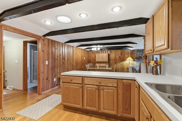 a dining room with furniture a chandelier and wooden floor