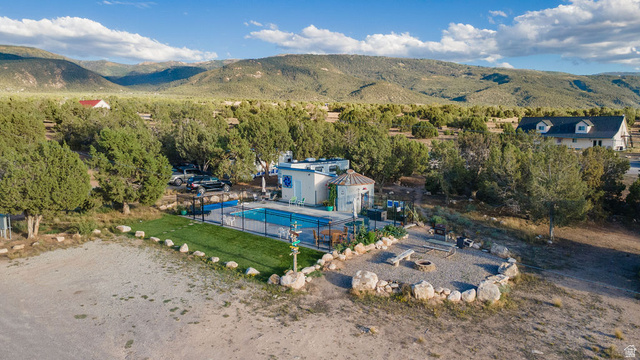 11550 Pigeon Hollow Road Spring City, UT 84662 - Photo 6 of 85 Outdoor pool, gravel fire pit area with stone seating, artificial turf, and extensive natural landscaping