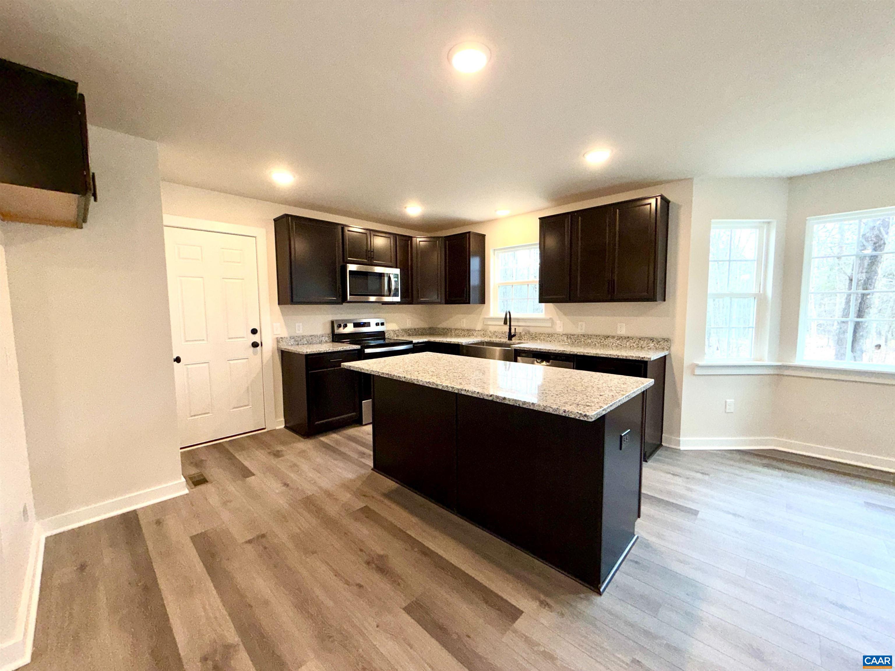 3546 Courthouse Road, Unit CBE4 Palmyra, VA 22963 - Photo 13 of 19 a kitchen with stainless steel appliances granite countertop a sink counter space and cabinets