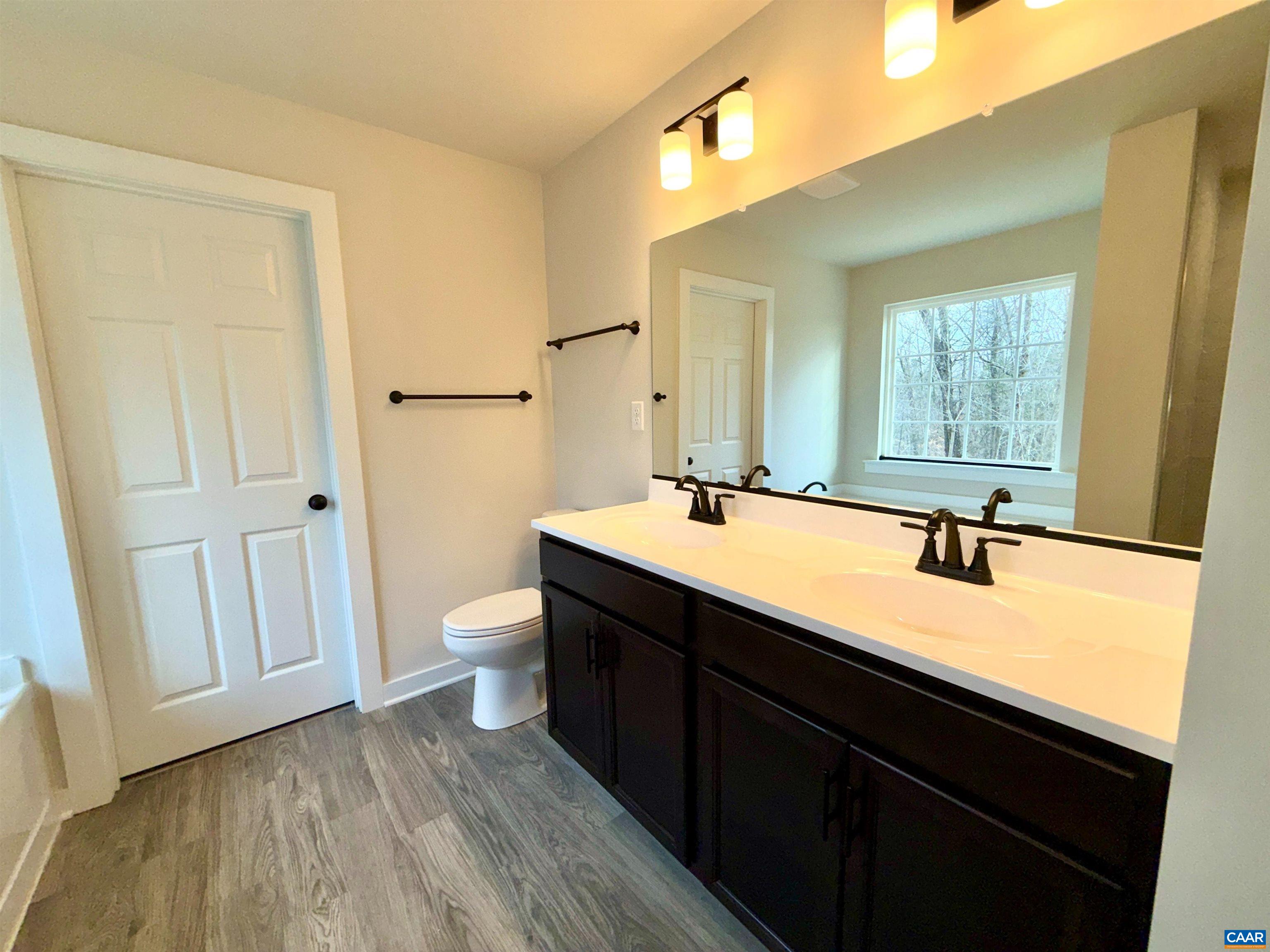 3546 Courthouse Road, Unit CBE4 Palmyra, VA 22963 - Photo 16 of 19 a bathroom with a double vanity sink a toilet and a window