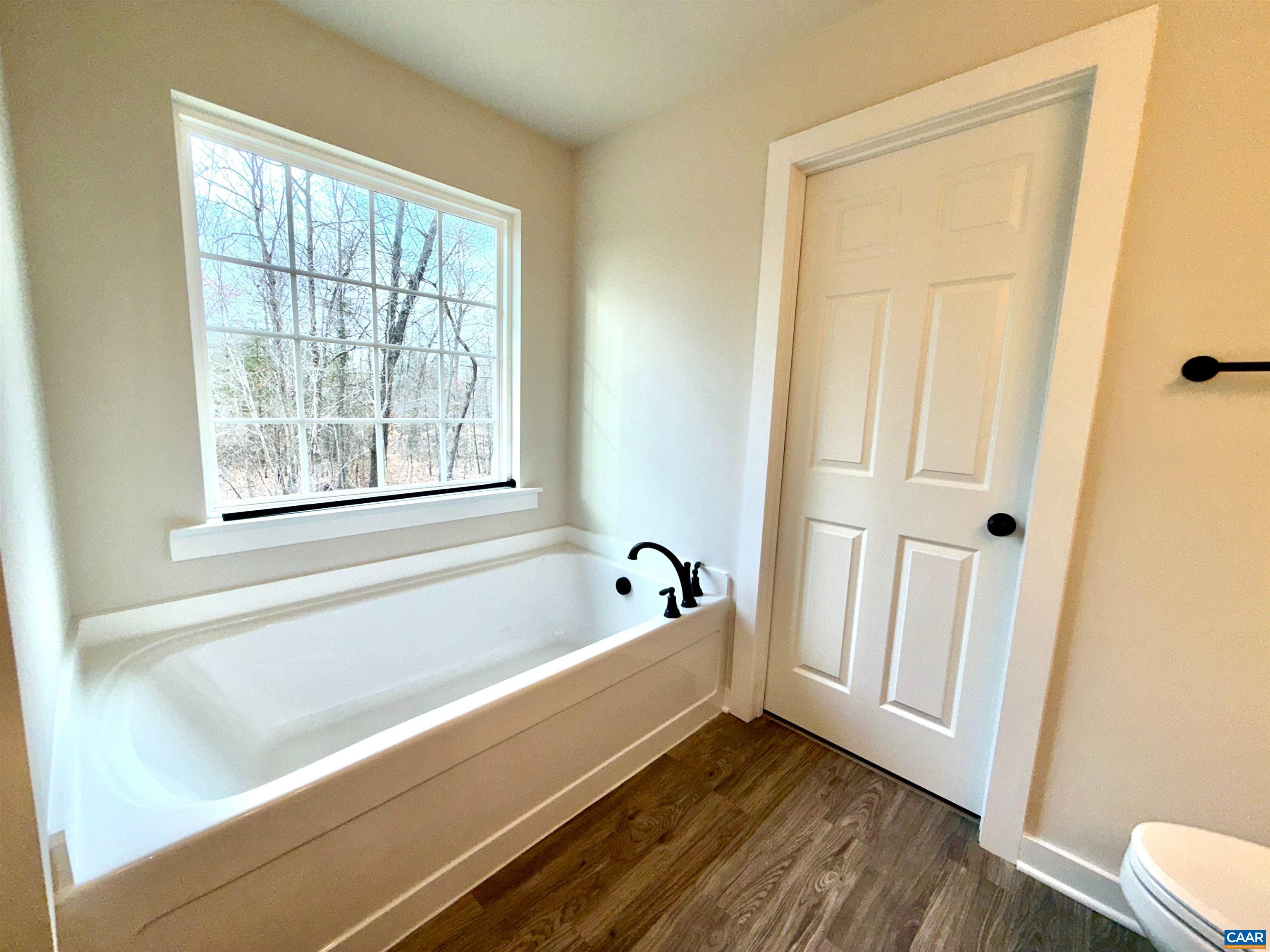 3546 Courthouse Road, Unit CBE4 Palmyra, VA 22963 - Photo 17 of 19 a bathroom with a bathtub and a window