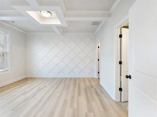 a kitchen with kitchen island white cabinets and stainless steel appliances