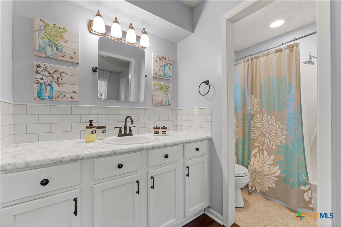 2014 Forest Trail Temple, TX 76502 - Photo 21 of 38 a bathroom with a double vanity sink mirror and toilet