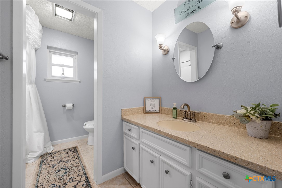 2014 Forest Trail Temple, TX 76502 - Photo 24 of 38 a bathroom with a sink a mirror and a toilet
