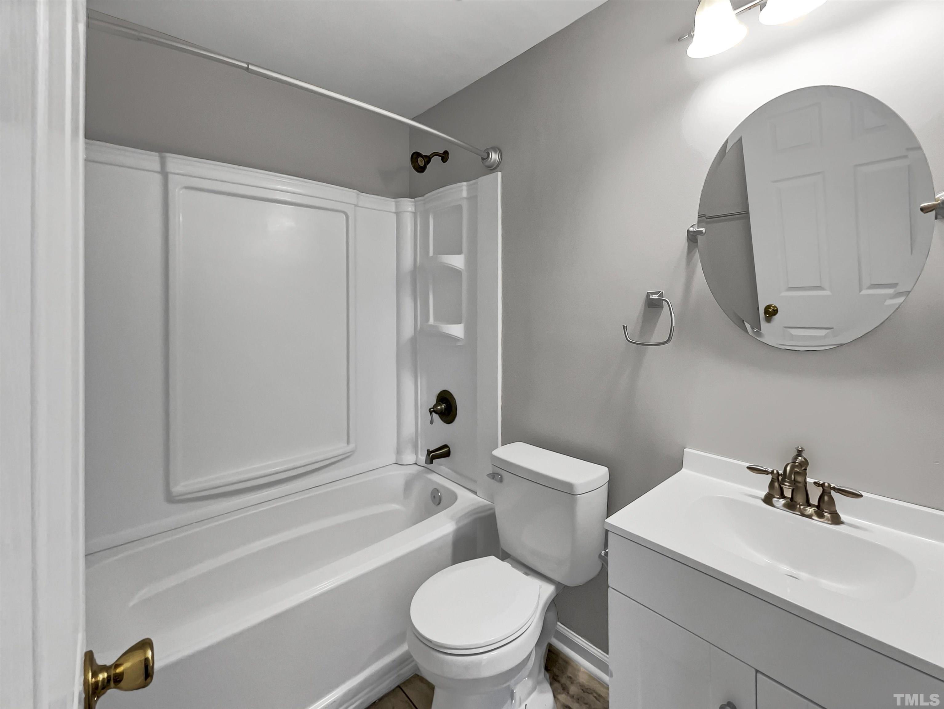 2829 Midway Park Court Raleigh, NC 27610 - Photo 13 of 16 a bathroom with a sink a toilet and a mirror