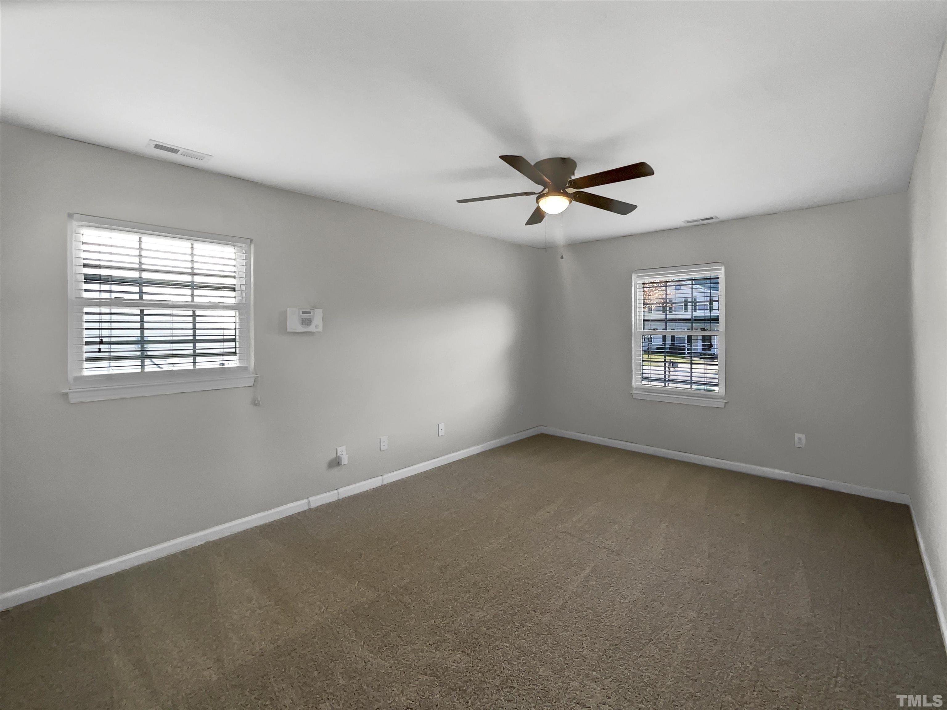 2829 Midway Park Court Raleigh, NC 27610 - Photo 14 of 16 an empty room with windows and ceiling fan