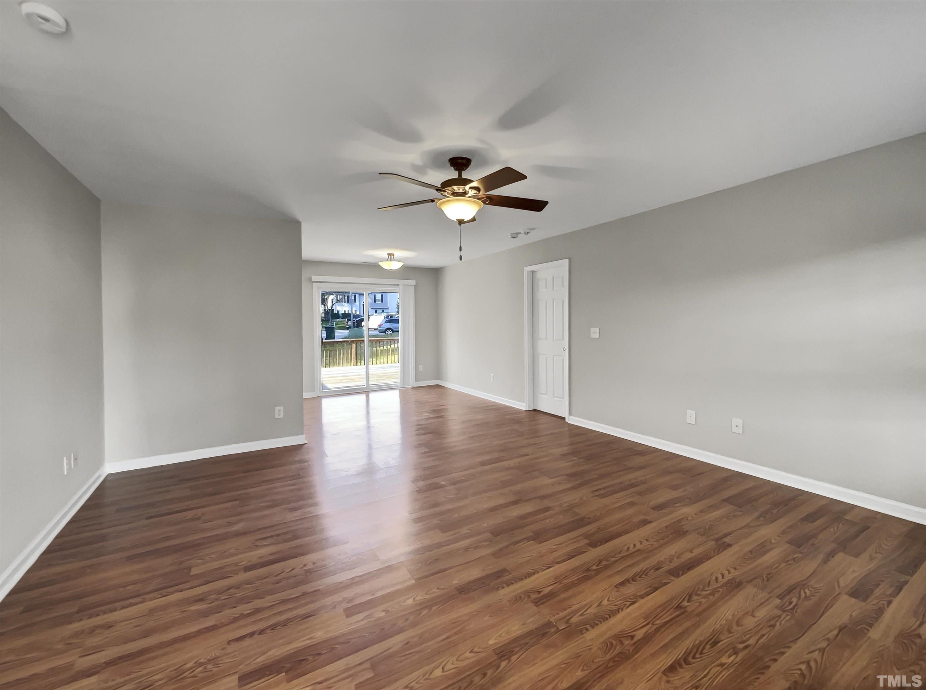 2829 Midway Park Court Raleigh, NC 27610 - Photo 3 of 16 a view of an empty room with window and wooden floor