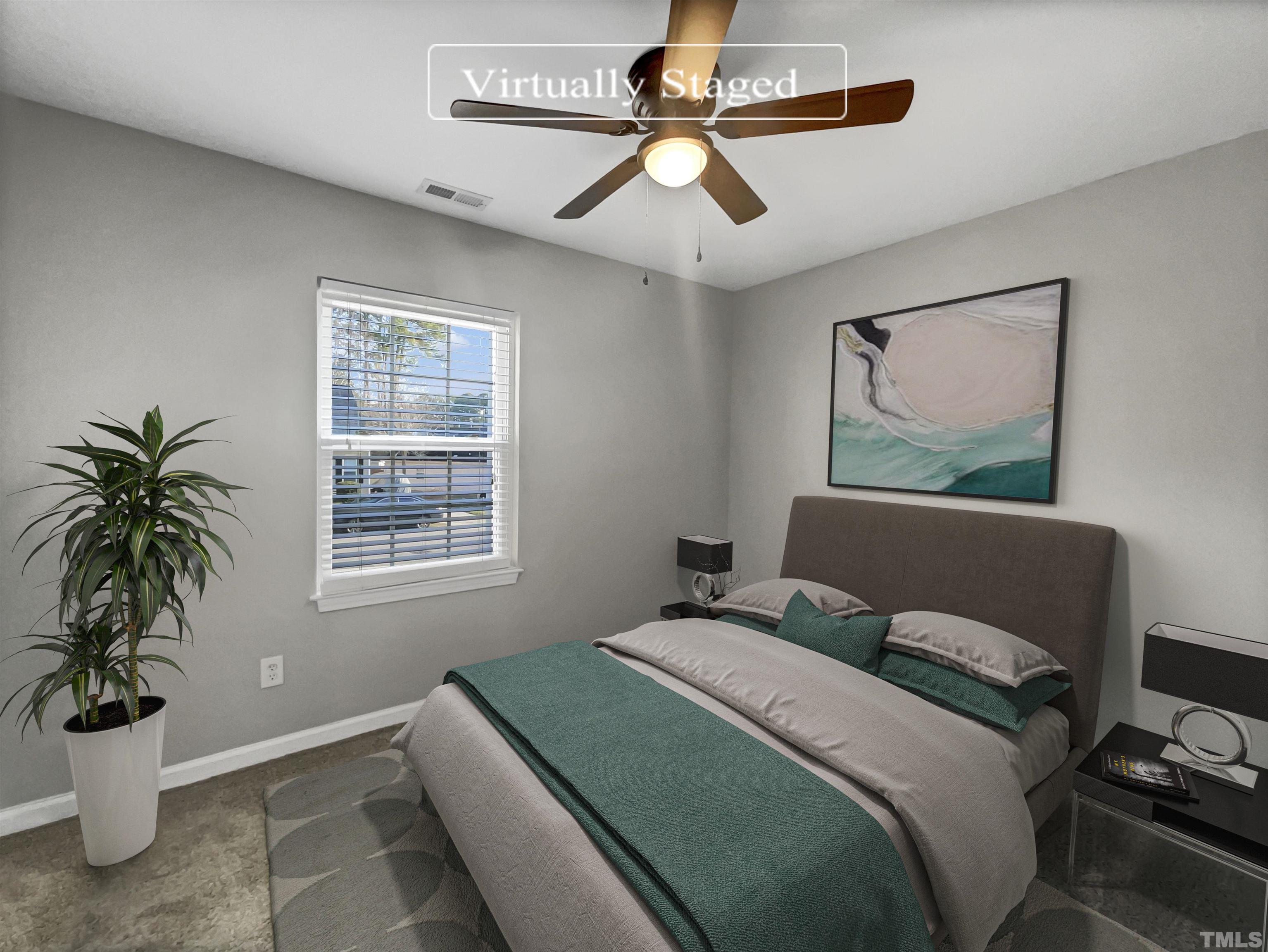 2829 Midway Park Court Raleigh, NC 27610 - Photo 4 of 16 a bedroom with a large bed and a window