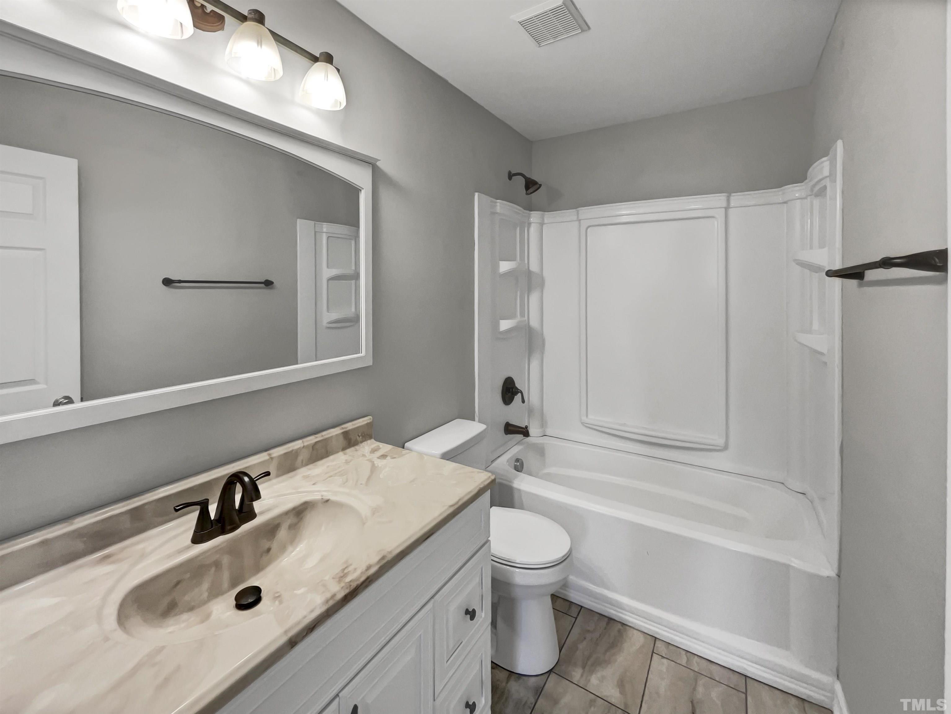 2829 Midway Park Court Raleigh, NC 27610 - Photo 7 of 16 a bathroom with a sink a toilet and shower