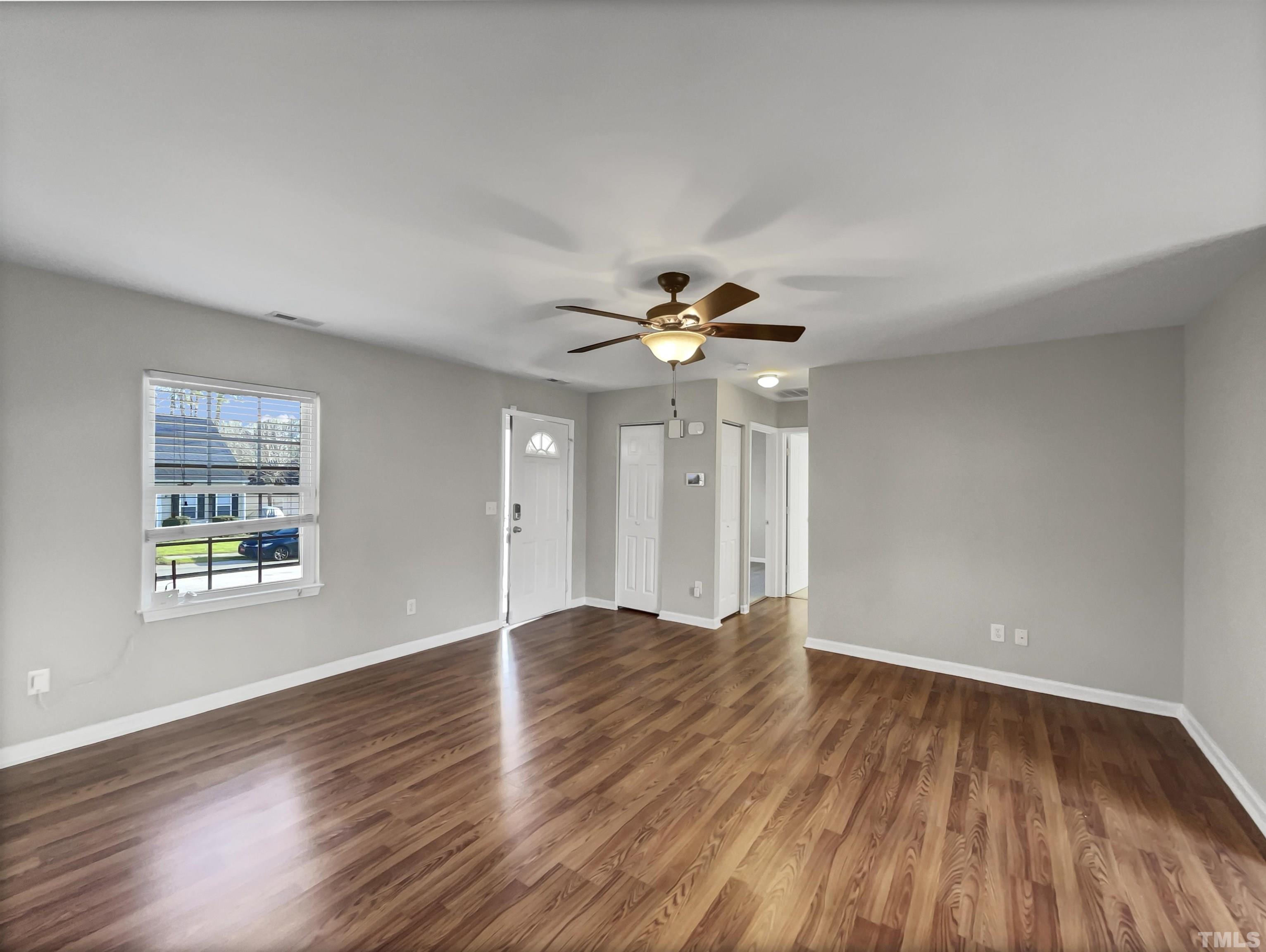 2829 Midway Park Court Raleigh, NC 27610 - Photo 9 of 16 a view of an empty room with wooden floor and a window