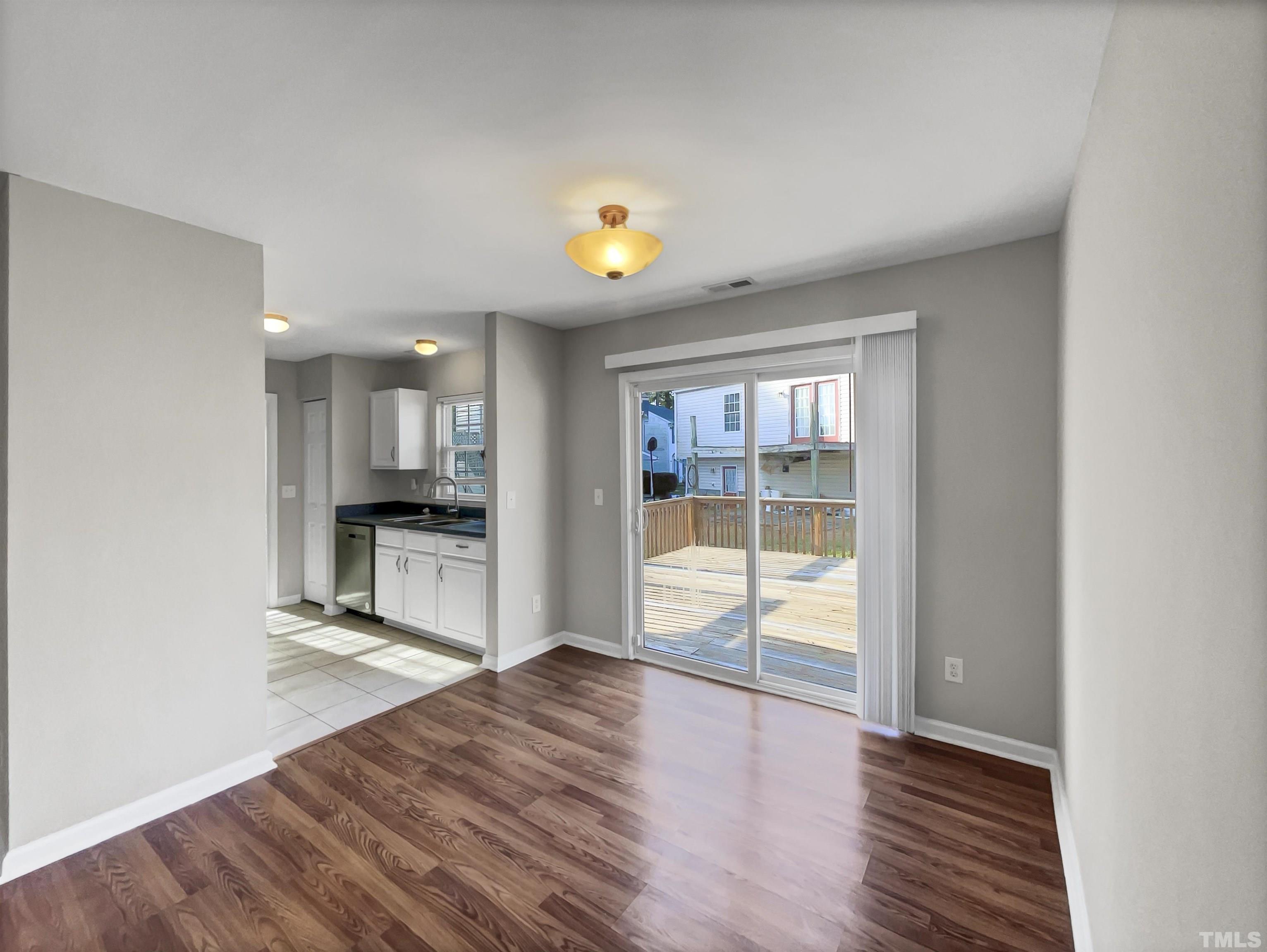 2829 Midway Park Court Raleigh, NC 27610 - Photo 10 of 16 a view of an empty room with wooden floor and a window