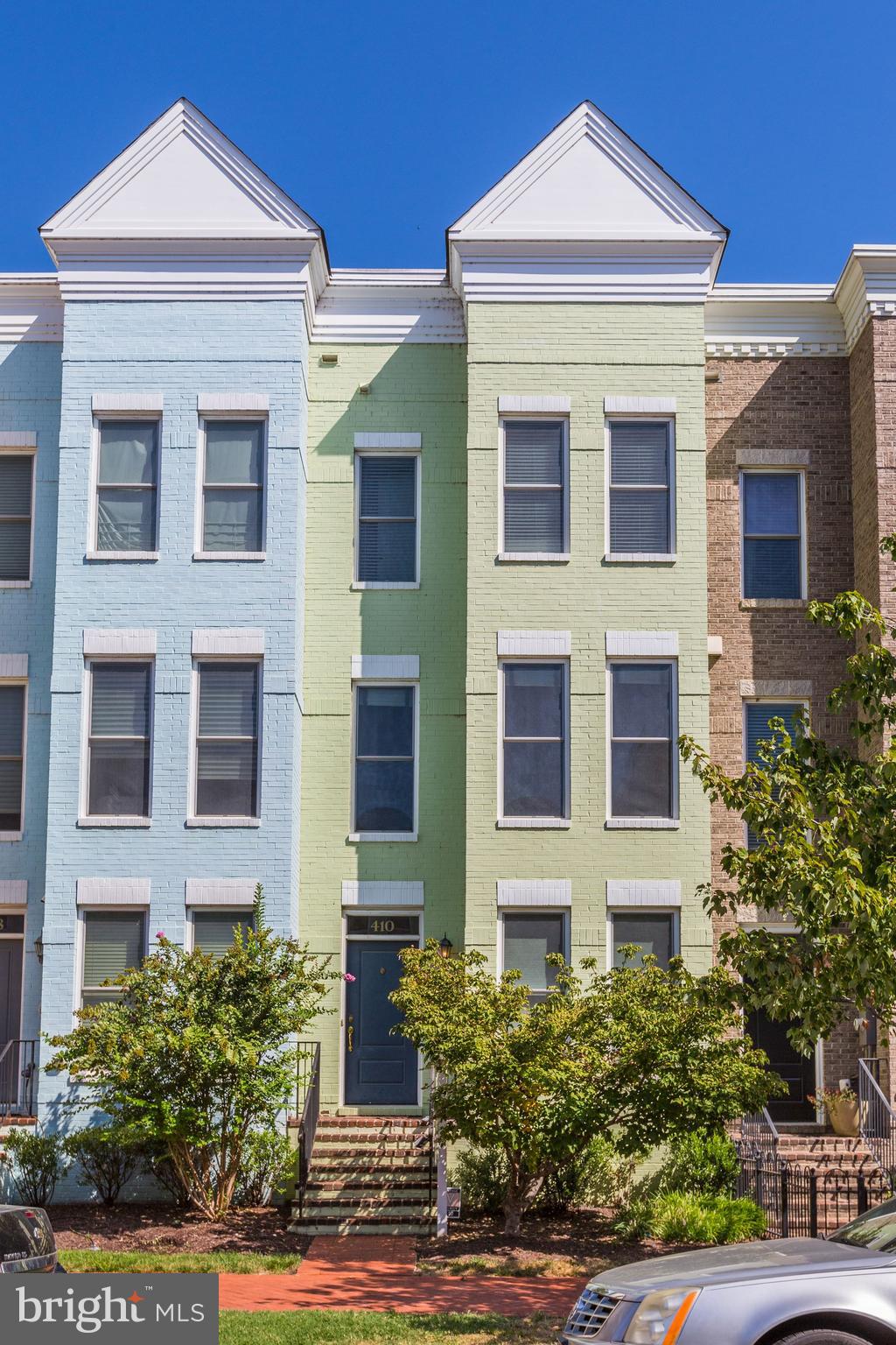 a front view of a house with plants