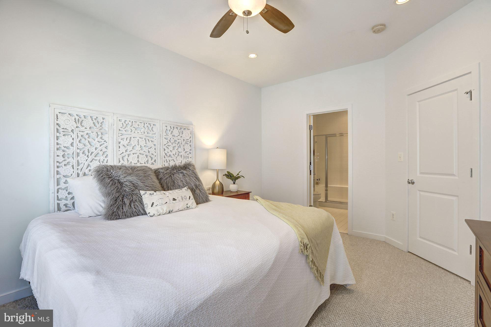 410 L Street Southeast Washington, DC 20003 - Photo 17 of 35 a bedroom with a bed and a ceiling fan