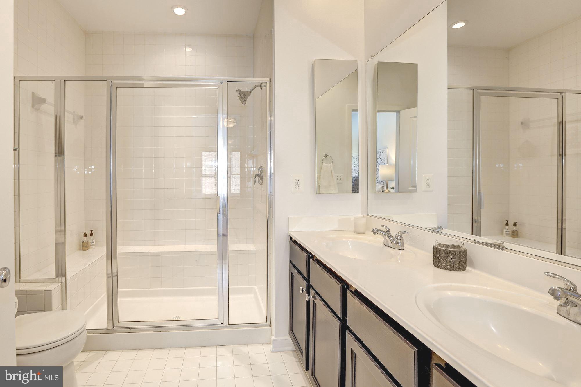 410 L Street Southeast Washington, DC 20003 - Photo 18 of 35 a bathroom with a double vanity sink mirror and shower