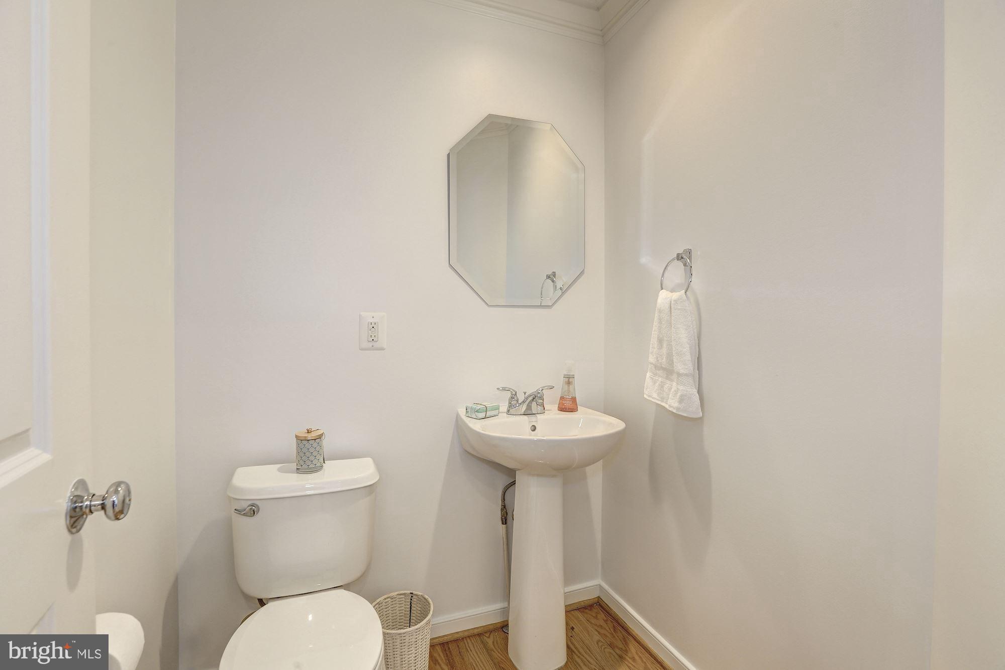 410 L Street Southeast Washington, DC 20003 - Photo 10 of 35 a bathroom with a toilet sink and mirror