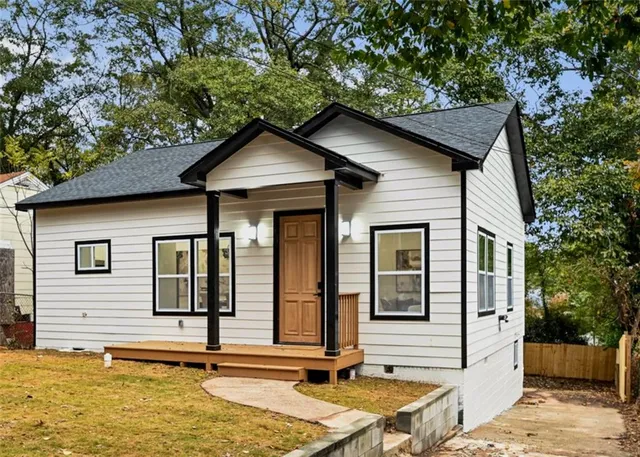 a kitchen with stainless steel appliances a refrigerator stove and white cabinets