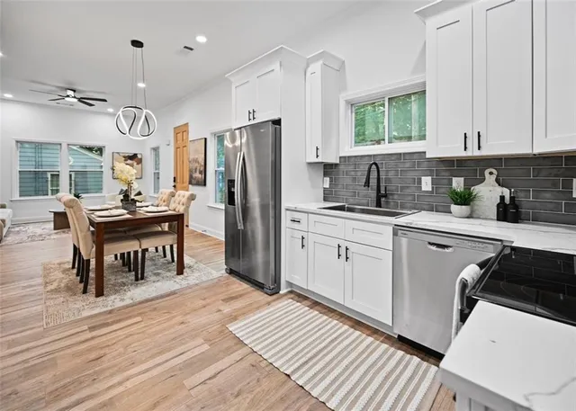 a kitchen with refrigerator cabinets and wooden floor