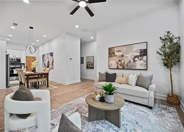 a living room with furniture and a potted plant