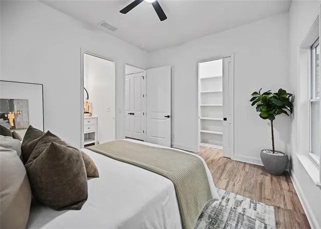 a bedroom with a bed and a potted plant