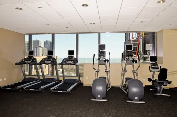a room with gym equipment and large mirror