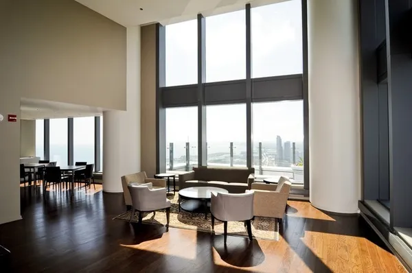 a living room with furniture and floor to ceiling windows