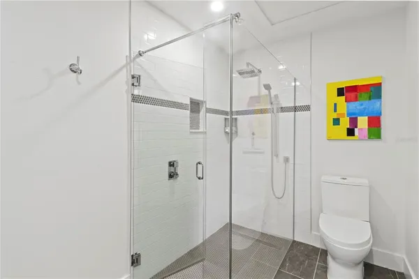 a bathroom with a shower toilet and sink