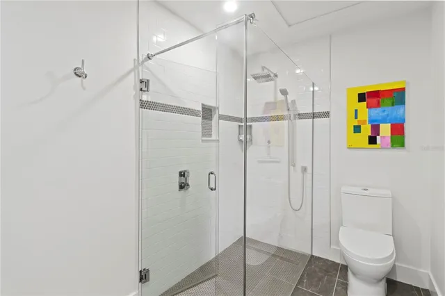 a bathroom with a shower toilet and sink