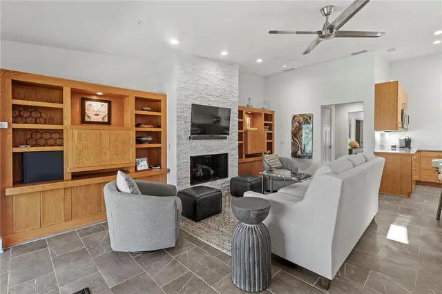 a living room with fireplace furniture and a flat screen tv