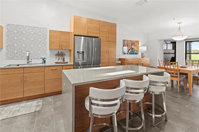 a kitchen with stainless steel appliances a refrigerator sink and cabinets