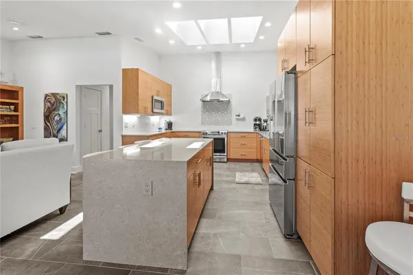 a large white kitchen with a large window