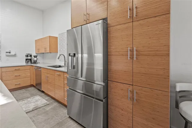 a kitchen with sink cabinets and stainless steel appliances