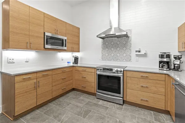 a bedroom with a bed couches and window