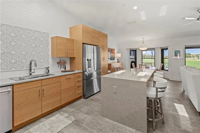 a bathroom with a granite countertop sink a toilet and a mirror