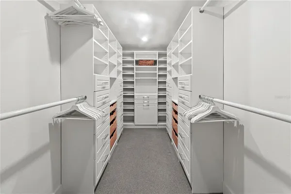 a bedroom with a bed and ceiling fan