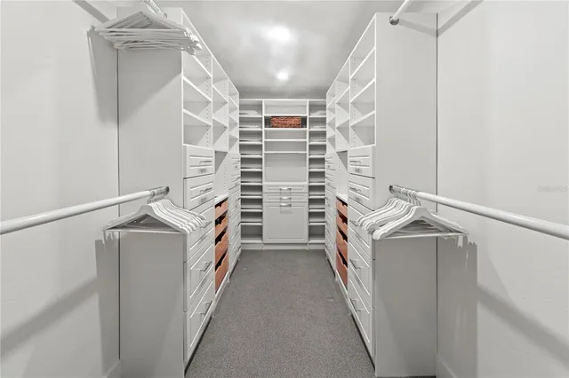 a bedroom with a bed and ceiling fan