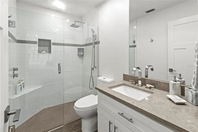 a view of a patio with a dining table and chairs with wooden floor