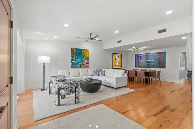 a living room with furniture and view of kitchen