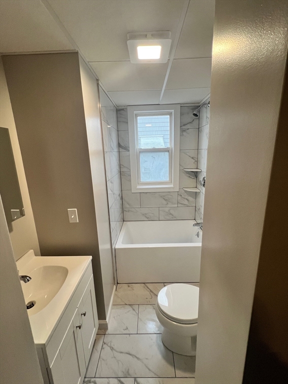 16 Morton Court, Unit 1 New Bedford, MA 02744 - Photo 2 of 4 a bathroom with a sink a toilet and bathtub