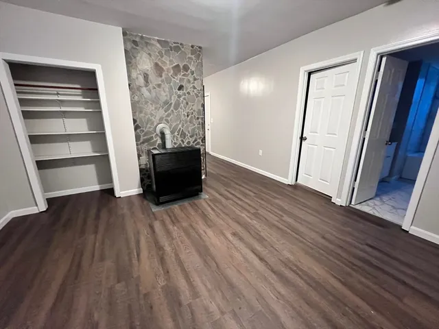 a view of a room with wooden floors and stairs